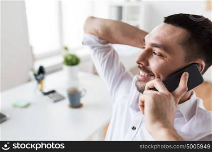 business, people, communication and technology concept - businessman calling on smartphone at office. businessman calling on smartphone at office