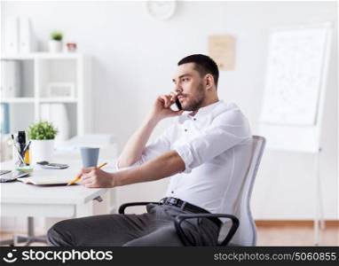 business, people, communication and technology concept - businessman calling on smartphone at office. businessman calling on smartphone at office