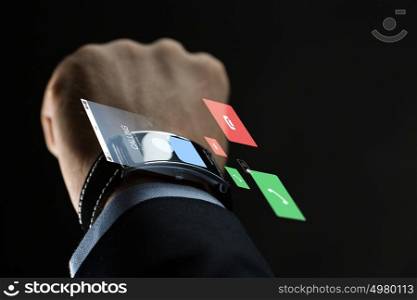 business, people, communication and technology concept - close up of businessman hand with smartwatch and incoming call virtual projection over black background. close up of businessman hand with smartwatch