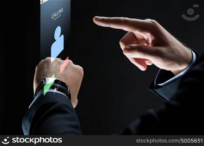 business, people, communication and technology concept - close up of businessman hands with smartwatch and incoming call virtual projection over black background. close up of businessman hands with smartwatch
