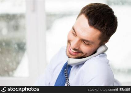 business, people, communication and technology concept - close up of smiling happy businessman calling on phone at office