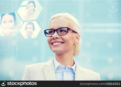 business, people, communication and technology concept - young smiling businesswoman and virtual screens with video chat outdoors