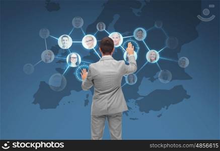 business, people, communication, cooperation and technology concept - businessman touching virtual screen with contacts icons and europe map over blue background