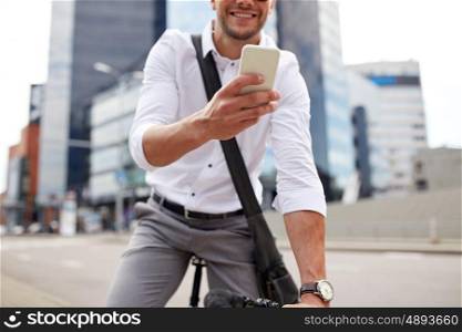 business, people, communication, technology and lifestyle - man texting on smartphone with fixed gear bike on city street