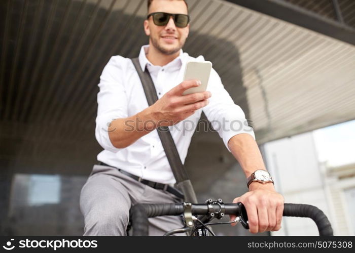 business, people, communication, technology and lifestyle - man texting on smartphone with fixed gear bike on city street. man with smartphone and fixed gear bike on street