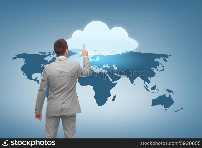 business, people, computing and technology concept - businessman pointing finger to cloud icon over blue background with world map from back
