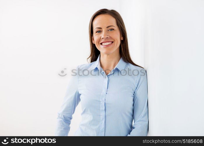 business people concept - happy smiling middle aged woman at office. happy smiling middle aged woman at office