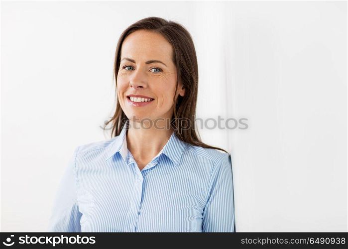business people concept - happy smiling middle aged woman at office. happy smiling middle aged woman at office. happy smiling middle aged woman at office