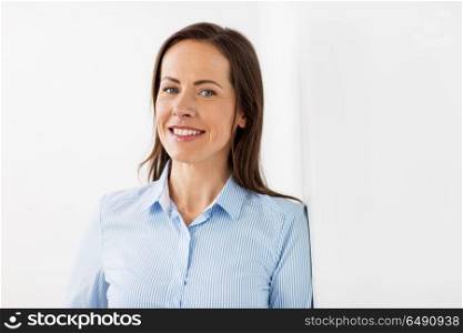 business people concept - happy smiling middle aged woman at office. happy smiling middle aged woman at office. happy smiling middle aged woman at office
