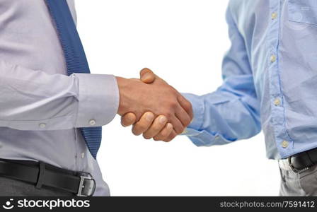 business people, cooperation, partnership and deal concept - close up of businessmen making handshake at office. close up of businessmen making handshake at office