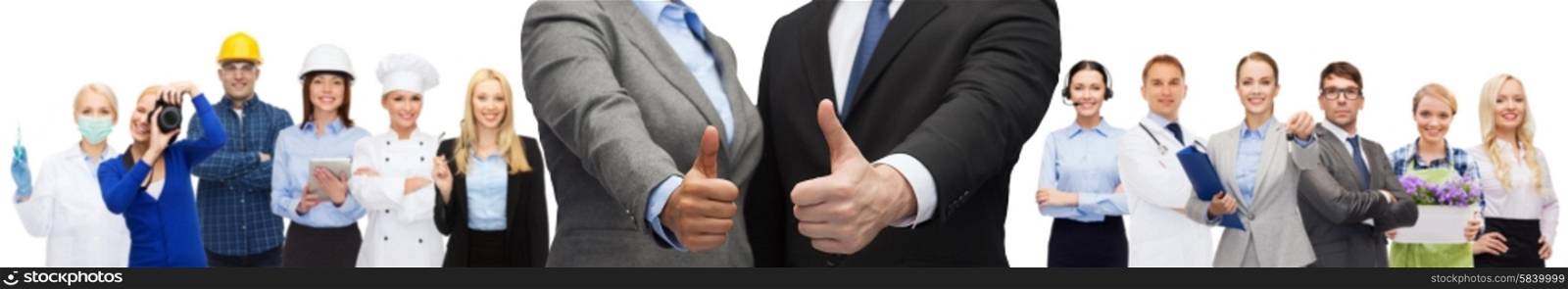 business, people, cooperation, success and gesture concept - businessman and businesswoman showing thumbs up over representatives of different professions background