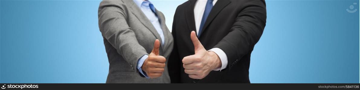 business, people, cooperation, success and gesture concept - businessman and businesswoman showing thumbs up over blue background