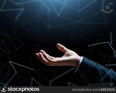business, people, cyberspace and future technology concept - close up of businessman empty hand over dark background