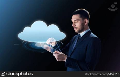 business, people, cyberspace, computing and modern technology concept - businessman in suit working with transparent tablet pc computer and cloud projection over black background. businessman with tablet pc and cloud projection