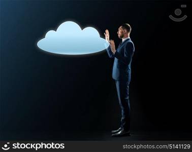 business, people, cyberspace, computing and office concept - businessman in suit with cloud projection over black background. businessman with cloud projection