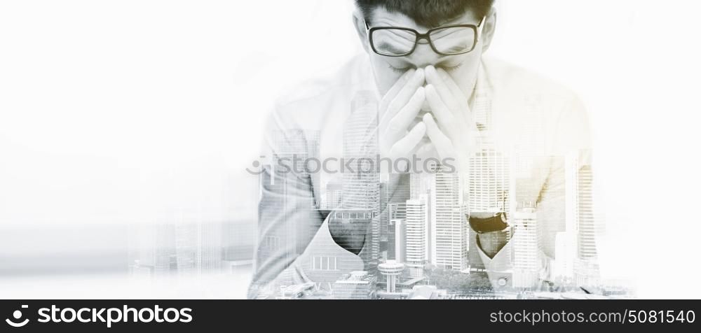 business, people, deadline and stress concept - tired businessman with eyeglasses at office over city buildings and double exposure effect. tired businessman with eyeglasses at office