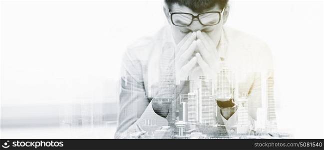 business, people, deadline and stress concept - tired businessman with eyeglasses at office over city buildings and double exposure effect. tired businessman with eyeglasses at office
