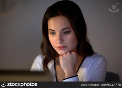 business, people, deadline and technology concept - businesswoman with laptop at night office. businesswoman with laptop at night office