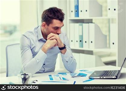 business, people, deadline and technology concept - stressed businessman with laptop computer and papers at office