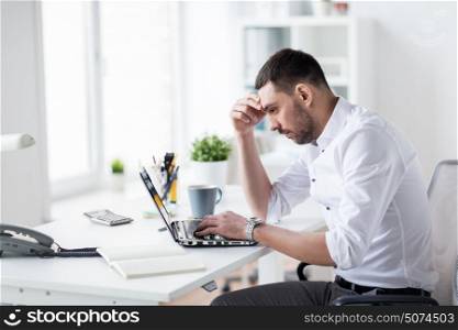 business, people, deadline and technology concept - stressed businessman with laptop computer at office. stressed businessman with laptop at office