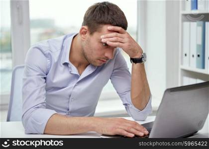 business, people, deadline and technology concept - stressed businessman with laptop computer at office