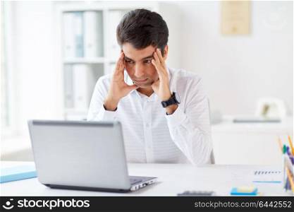 business, people, deadline and technology concept - stressed businessman with laptop computer at office. stressed businessman with laptop at office
