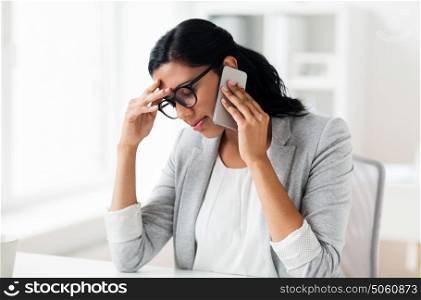 business, people, deadline and technology concept - stressed businesswoman calling on smartphone at office. stressed businesswoman with smartphone at office