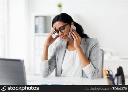 business, people, deadline and technology concept - stressed businesswoman calling on smartphone at office. stressed businesswoman with smartphone at office. stressed businesswoman with smartphone at office