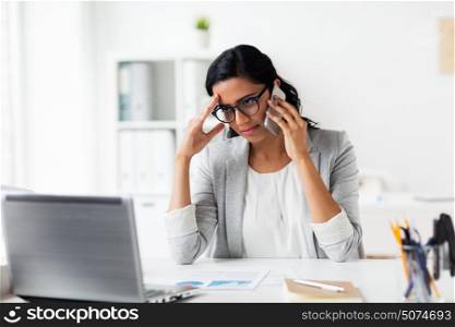 business, people, deadline and technology concept - stressed businesswoman with laptop computer and papers calling on smartphone at office. stressed businesswoman with smartphone at office