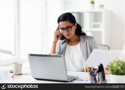 business, people, deadline and technology concept - stressed businesswoman with laptop computer and papers at office. stressed businesswoman with laptop at office