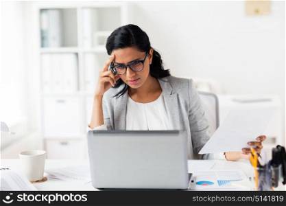 business, people, deadline and technology concept - stressed businesswoman with laptop computer and papers at office. stressed businesswoman with laptop at office