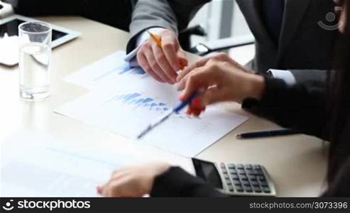 Business people discuss financial reports close up view