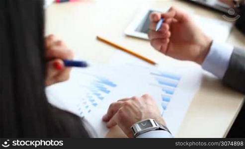 Business people discuss financial reports close up view
