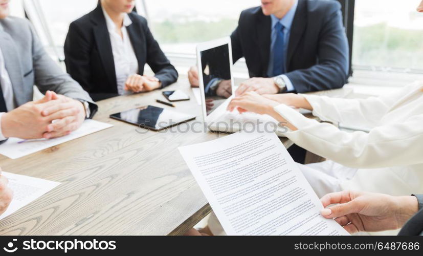 Business people discussing contract. Group of business people and lawyers discussing contract papers sitting at the table, close up