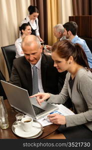 Business people discussion woman point laptop at restaurant conference room