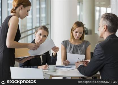 Business people doing paperwork in office cafeteria