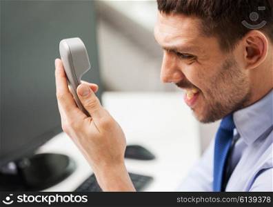 business, people, emotions, stress and communication concept - angry businessman calling on phone in office