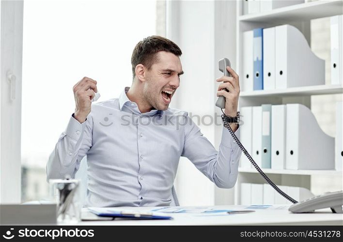 business, people, emotions, stress and communication concept - furious businessman calling on phone in office