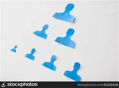 business, people, employment, career and hiring concept - close up of paper human shapes on white board