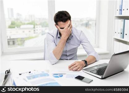 business, people, fail, paperwork and technology concept - businessman with laptop computer and papers working in office