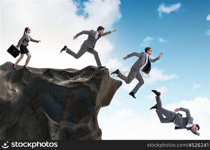 Business people falling off the cliff