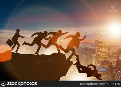 Business people falling off the cliff
