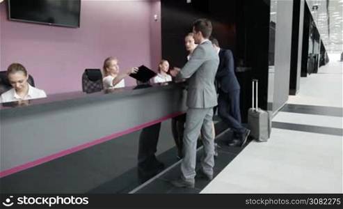 Business people filling forms at reception front desk