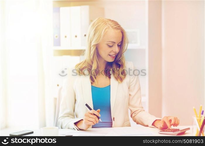 business, people, finance and accounting concept - smiling businesswoman with calculator counting and filling tax form at office. businesswoman with calculator counting at office