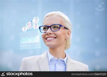 business, people, future technology and communication concept - young smiling businesswoman in eyeglasses with virtual screen, video chat and charts projection outdoors