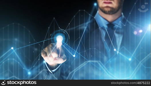 business, people, future technology and cyberspace concept - close up of businessman touching charts projection on virtual screen over dark background