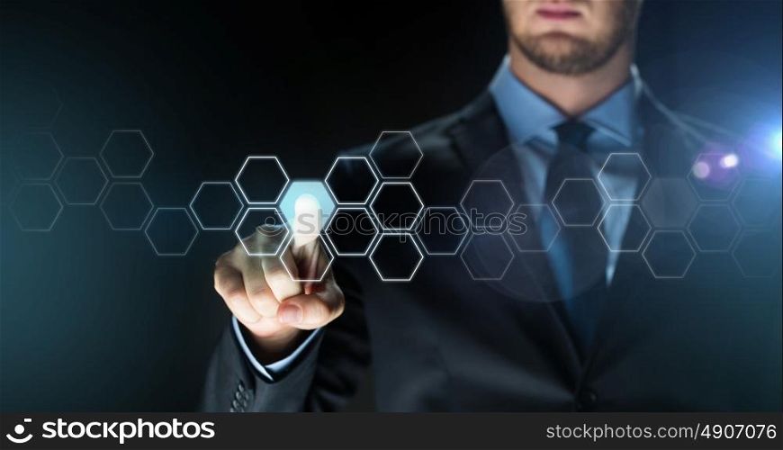 business, people, future technology, network and cyberspace concept - close up of businessman in suit touching virtual reality screen with hexagonal projection over dark background. businessman touching virtual hexagonal projection