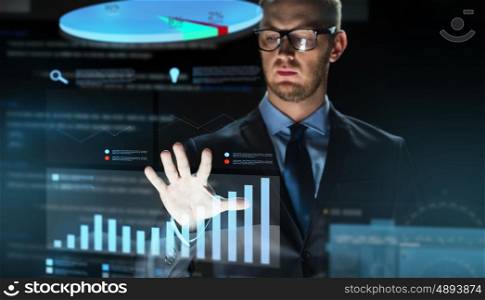 business, people, future technology, statistics and economics concept - close up of businessman touching chart projection on virtual screen over dark background