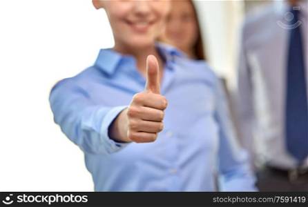 business people, gesture and success concept - close up of happy smiling businesswoman showing thumbs up. close up of happy businesswoman showing thumbs up