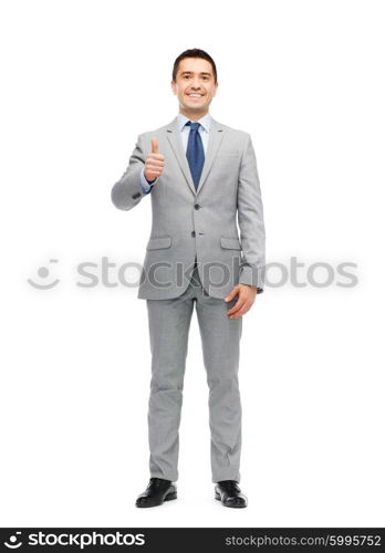 business, people, gesture and success concept - happy smiling businessman in suit showing thumbs up